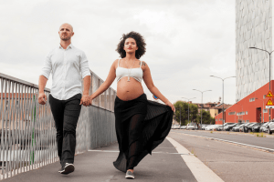 Gorgeous couple walking. Benefits of walking during pregnancy. Can it help with an easier labor??