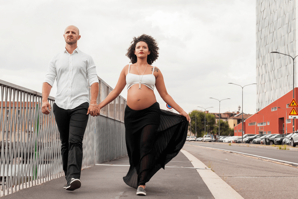 Gorgeous couple walking. Benefits of walking during pregnancy. Can it help with an easier labor??