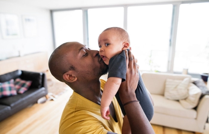 Dad kissing baby