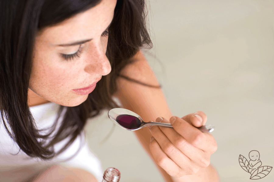 Breastfeeding woman drinking elderberry syrup