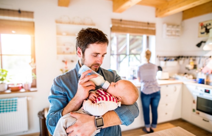 dad feeding baby a bottle