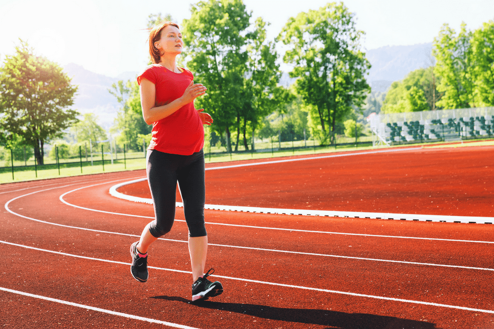 pregnant woman running on track