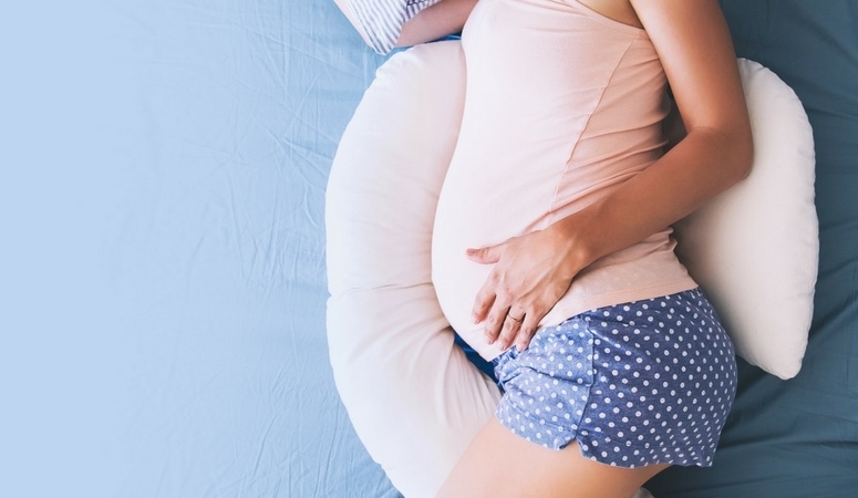 Pregnant woman sleeping will pregnancy pillow under belly prevent back pain