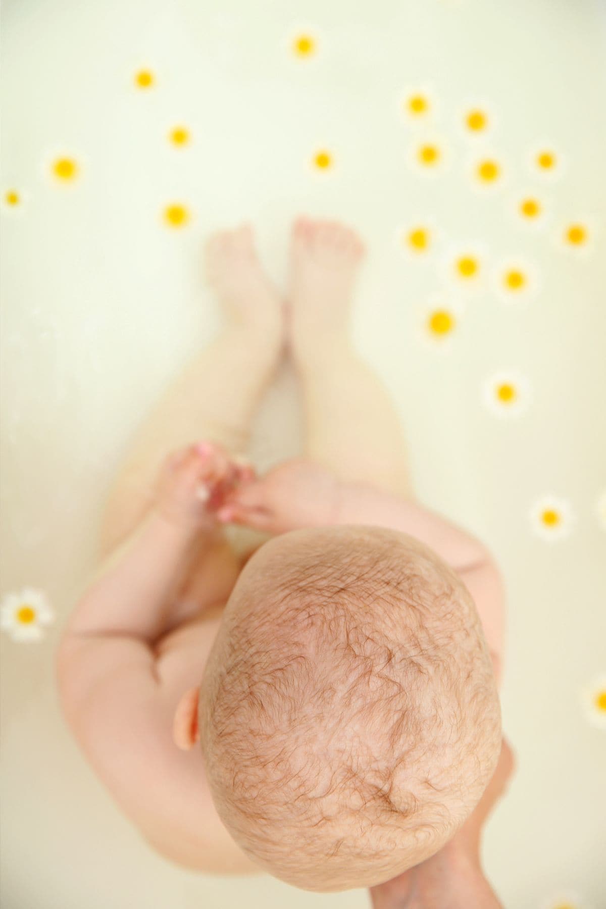 baby in chamomile bath to soothe teething pain